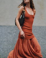Woman walking with flowy skirt and shoulder bag