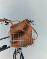 tote bag in a bicycle's front wire basket