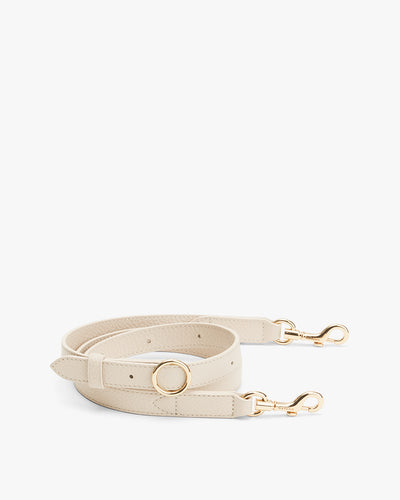 Leather belt with metal clasps and a circular buckle.
