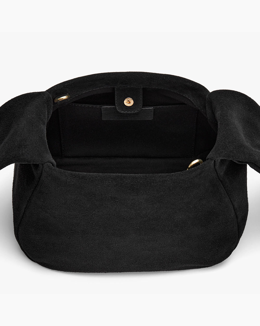 Open handbag viewed from the top showing inner compartment.