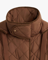 Close-up of a quilted jacket with a high collar and zipper.