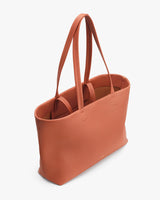 Tote bag with two handles standing upright.