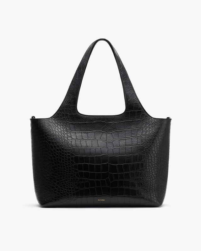 Large handbag with textured design and two handles.