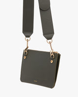 Handbag with a long strap and metal clasps.