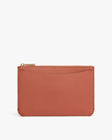 Flat purse with a zipper on plain background