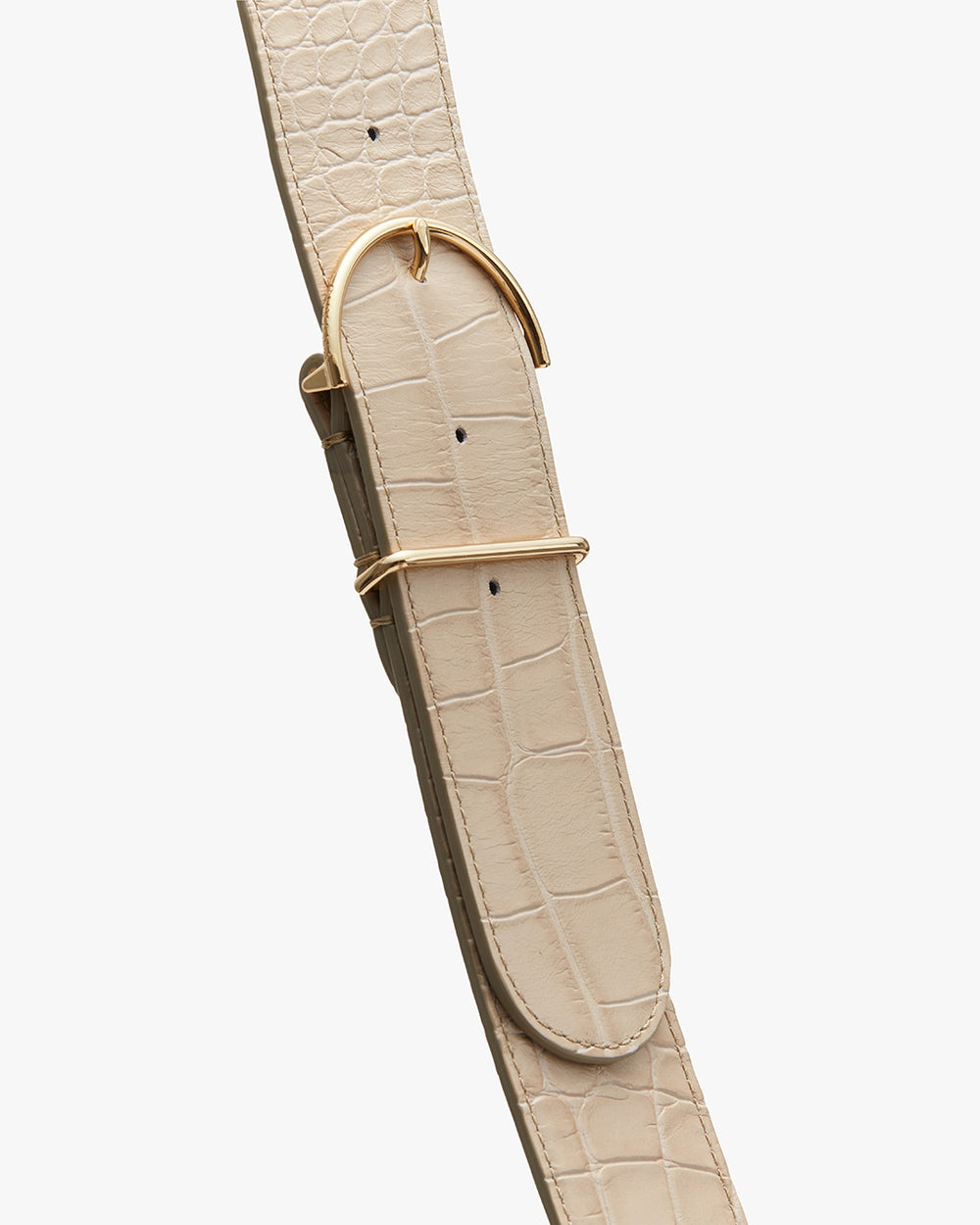 Close-up of a textured watch strap with a metal buckle.
