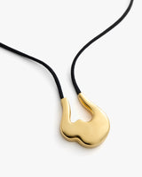 Pendant necklace with black cord and gold abstract-shaped charm