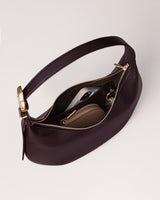 Handbag open showing phone and wallet inside.