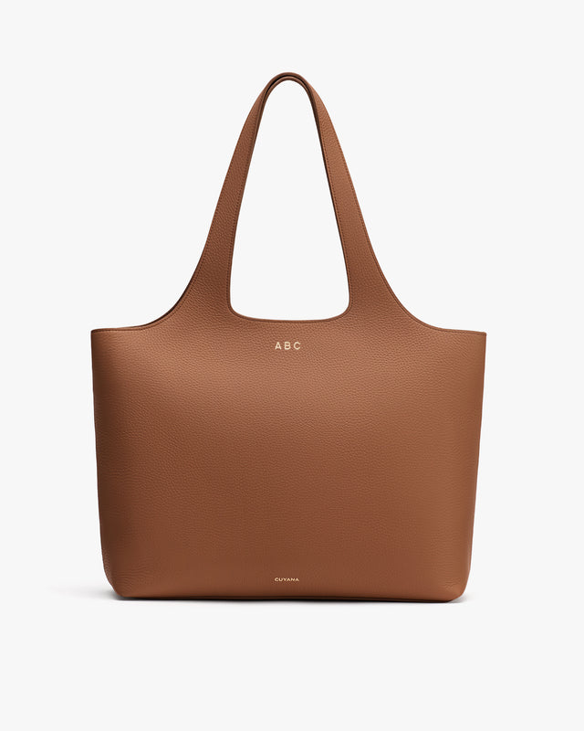 Large tote bag with two handles and minimal design.