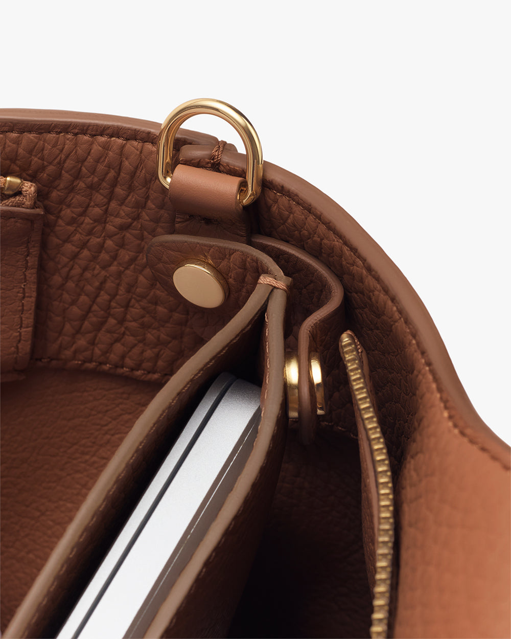 Open handbag showing interior compartments and hardware details