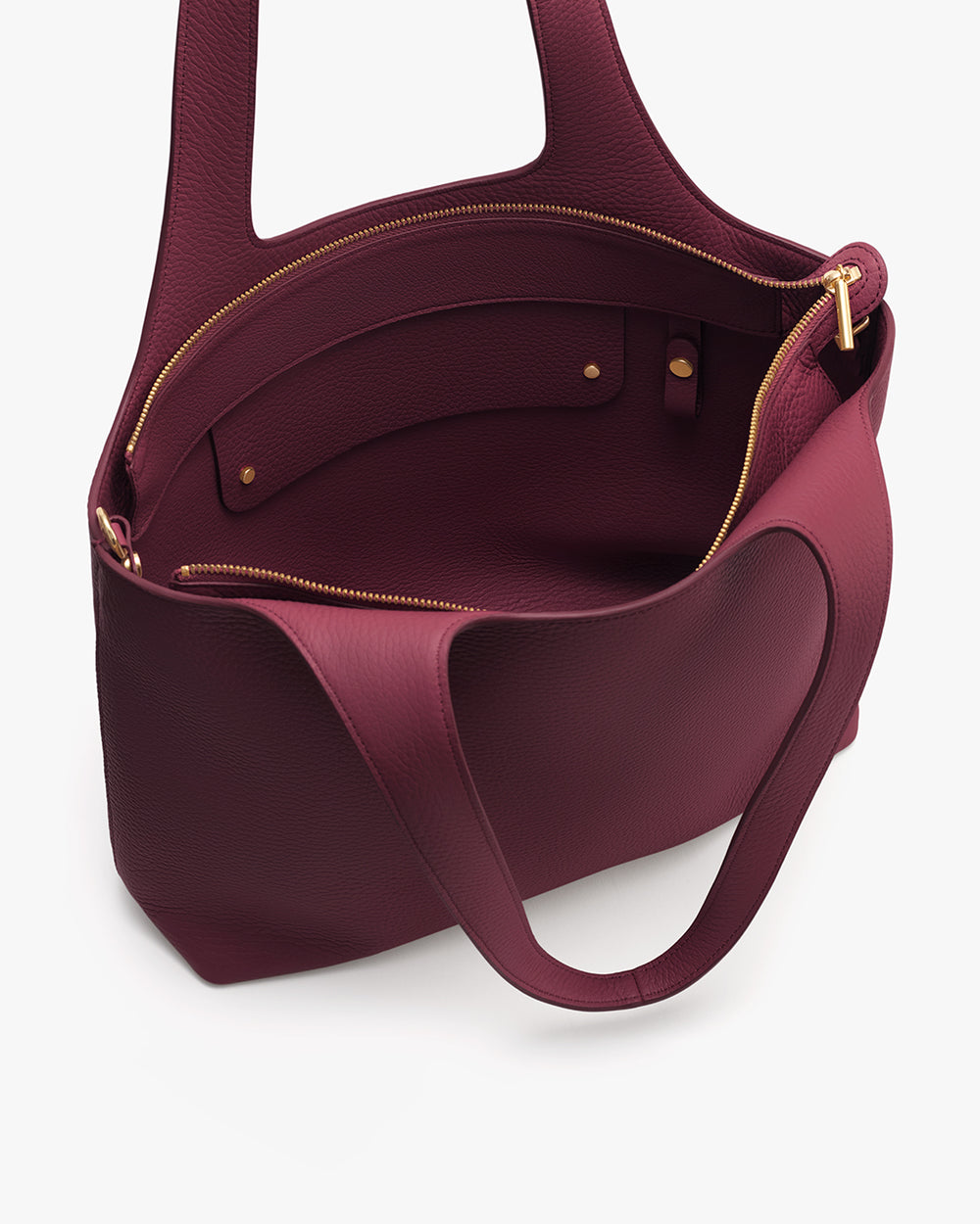 Open handbag with two handles and visible zipper pocket inside.