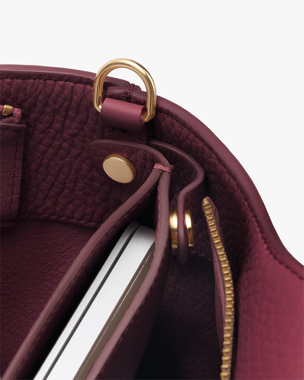 Close-up of a bag's interior with a tablet or laptop inside.