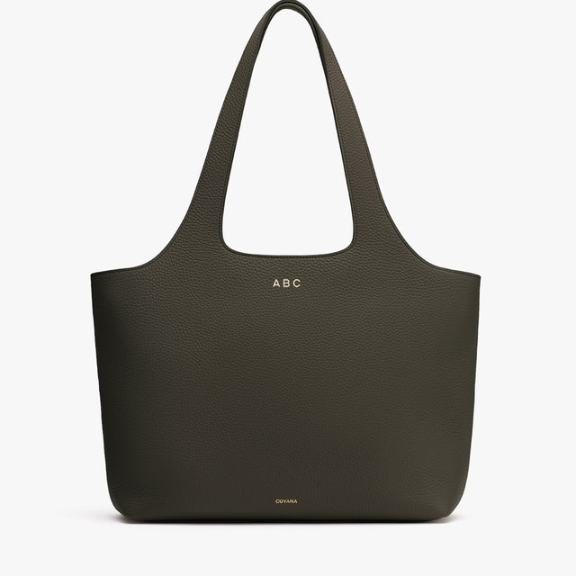 Large tote bag with two handles and embossed initials near the top.