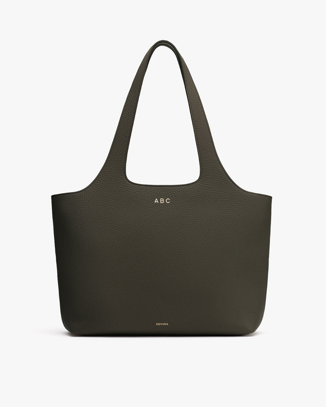 Large tote bag with two handles and embossed initials near the top.