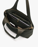 Open handbag with visible compartments containing a phone and a tablet.