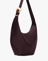 Bag with a single strap and curved shape, featuring a zippered top closure.