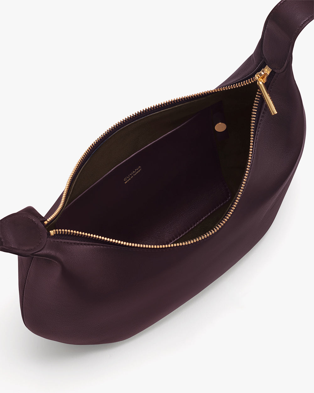 Opened handbag showing interior pocket and zipper closure.