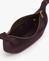 Opened handbag showing interior pocket and zipper closure.
