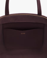 Open handbag with visible interior pocket and zipper.