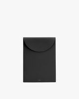 Rectangular leather laptop sleeve bag with a flap closure.