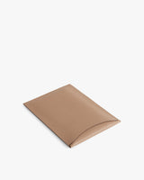 Rectangular leather laptop sleeve with a curved flap closure.