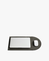 Laptop and mouse on a flattened laptop sleeve.