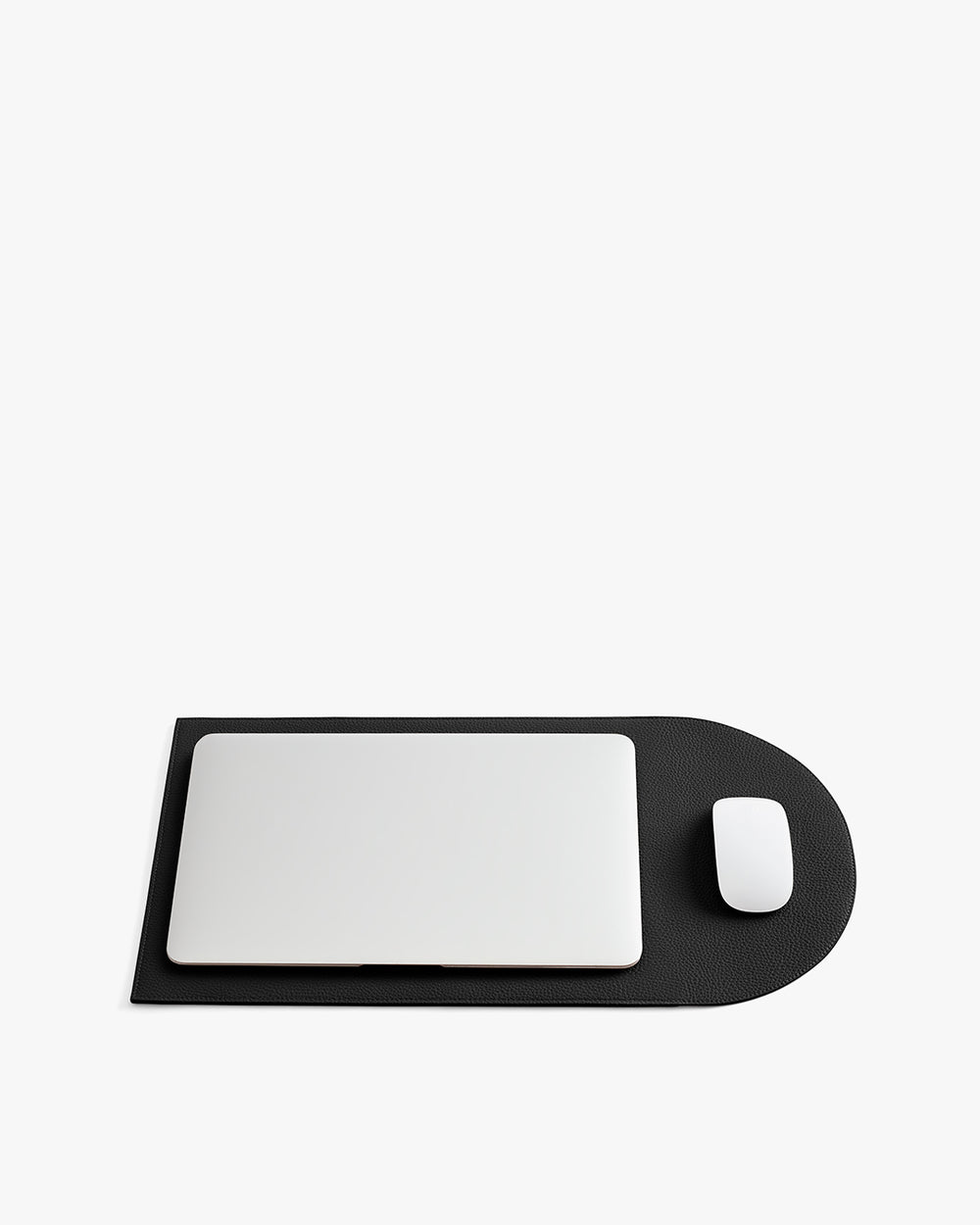 Laptop and mouse on a rectangular mat with a rounded end