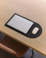 Laptop and mouse on a flattened laptop sleeve.