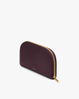 Small, half-moon shaped wallet with zipper.