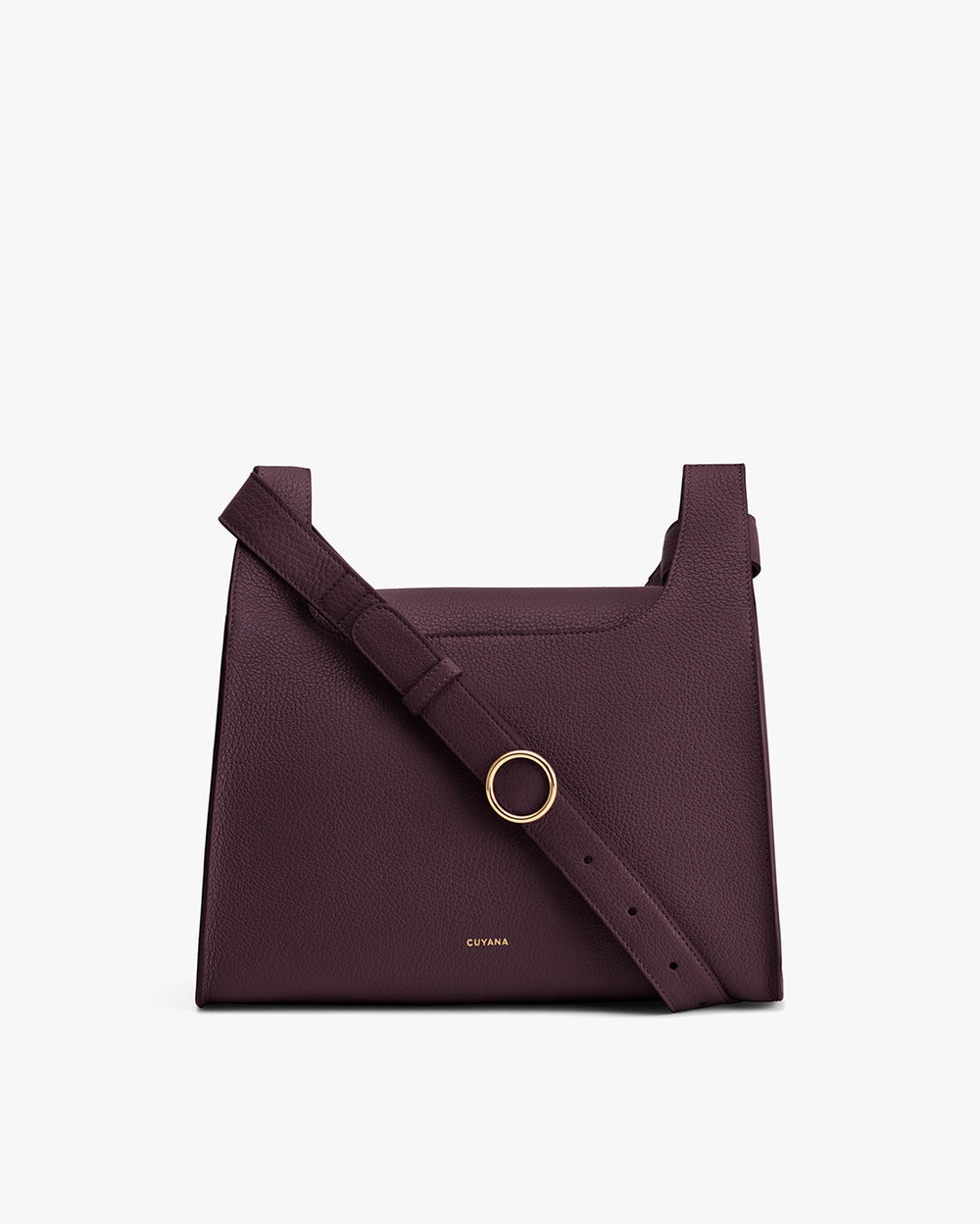 Shoulder bag with a strap and small metallic ring on the front.