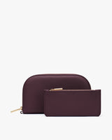 Two leather wallets with zippers, one larger and one smaller.