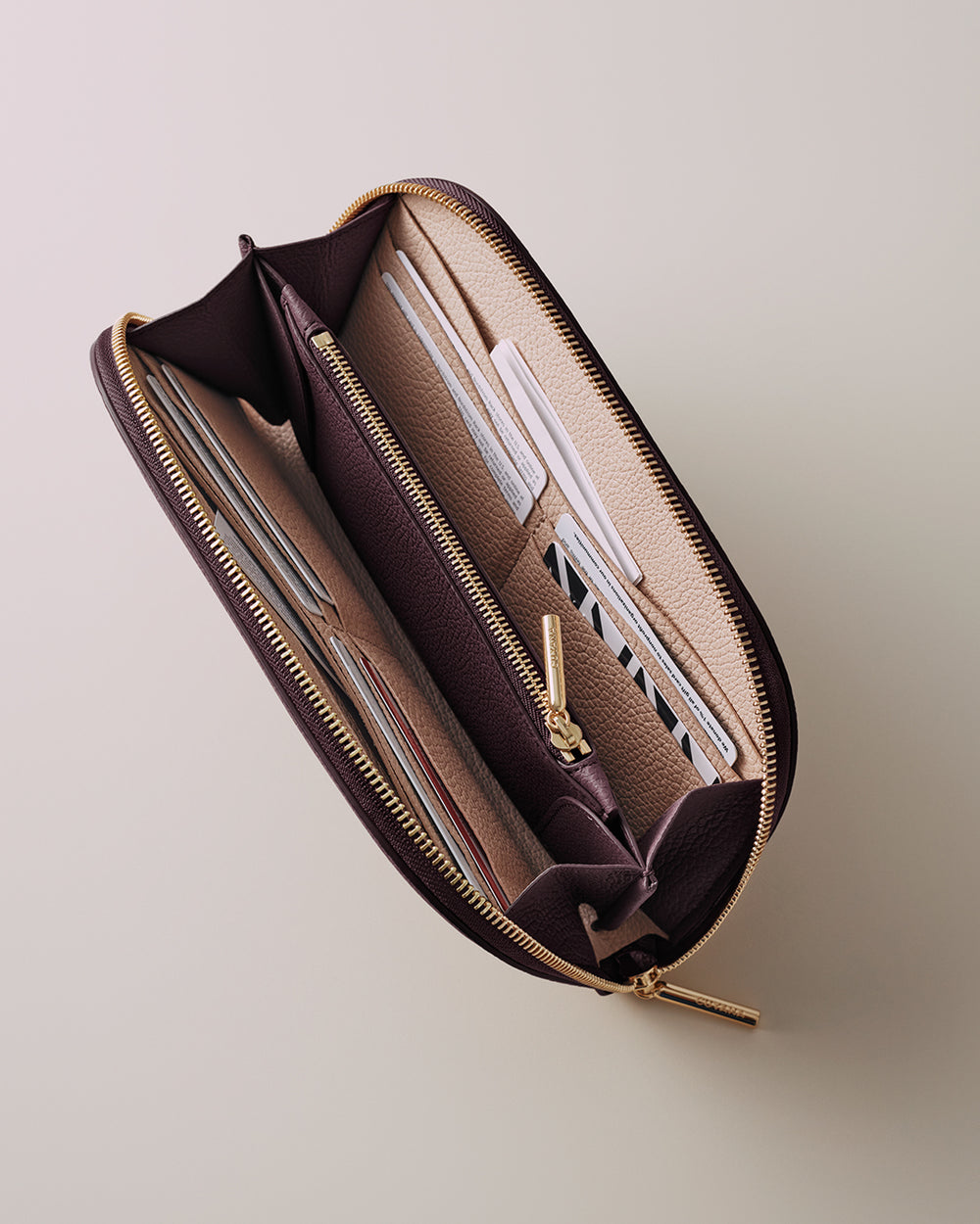 Open wallet with multiple card slots and a central zippered section.
