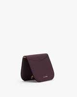 Small, folded cardholder with subtle gold text on the front.