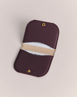 Open cardholder with a snap button and cards inside.
