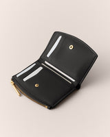 Open wallet with card slots and a zipper compartment shown.