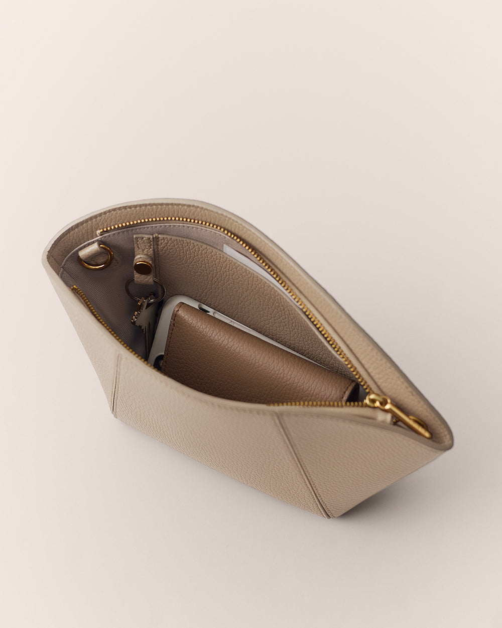 Open handbag with visible compartments and items inside.