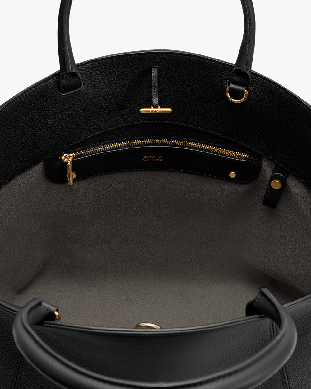 Open handbag interior with a zippered pocket and two handles.