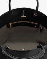 Open handbag interior with a zippered pocket and two handles.