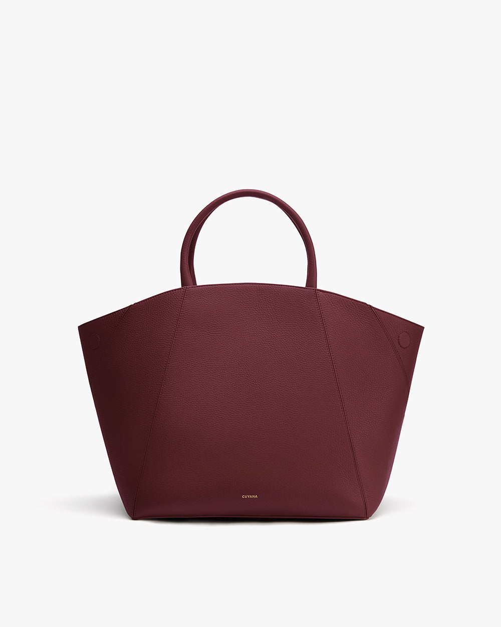 Handbag with curved handles and geometric design.