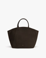 Large tote bag with curved handles on plain background