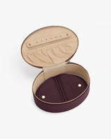 Open oval-shaped zippered case with compartments inside