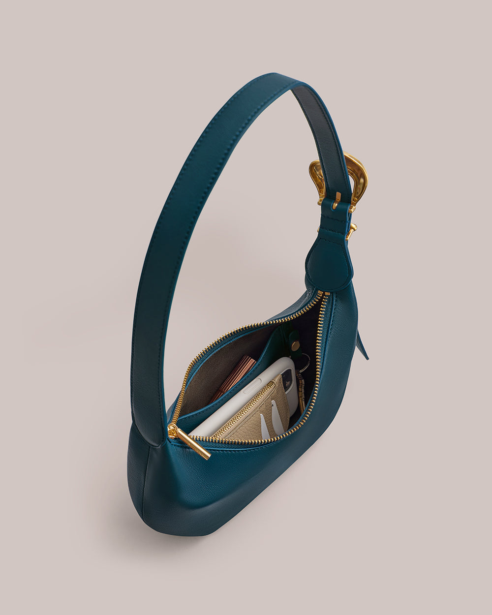 Handbag with open zipper showing contents like a phone and wallet
