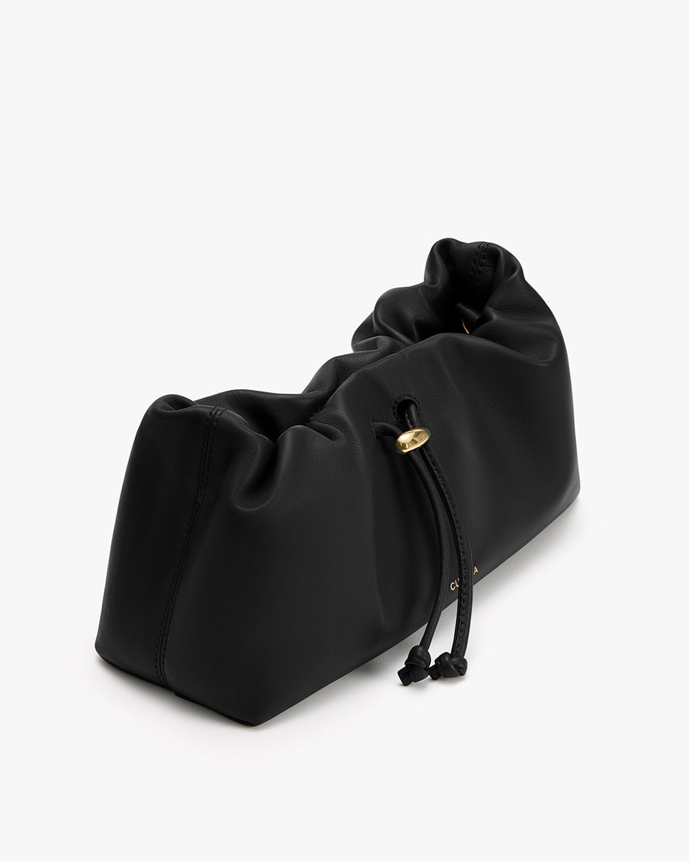 Soft drawstring bag with gathered top lying on a surface.