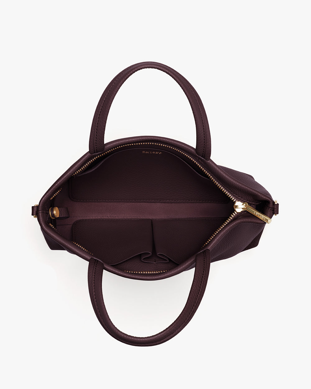 Open handbag with two handles and a zipper, showing interior compartments.