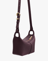 Shoulder bag with an adjustable strap and zippered top.