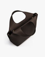 Handbag with curved handle and detachable strap