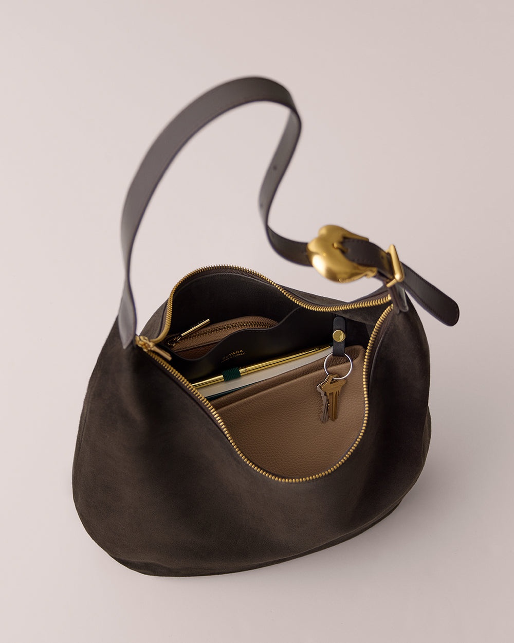 Open bag with key, wallet, and pen inside.