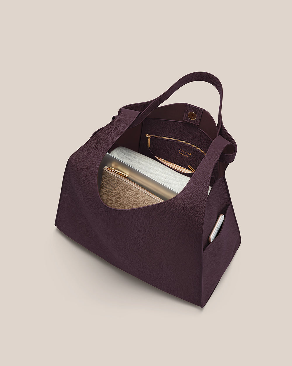 Open handbag with a pouch, phone, and other small items inside