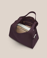 Open handbag with a pouch, phone, and other small items inside