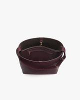 Open handbag with visible interior pockets and strap.